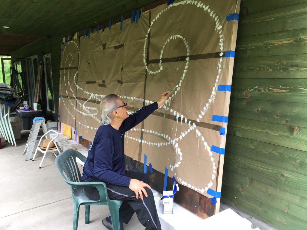 The painting "Rabbit Hole" by Stephen Zaima in progress. The images shows the large cartoon (a full-scale preparatory drawing) was punched with holes and used to paint marks that form a pattern once the paper is removed. 